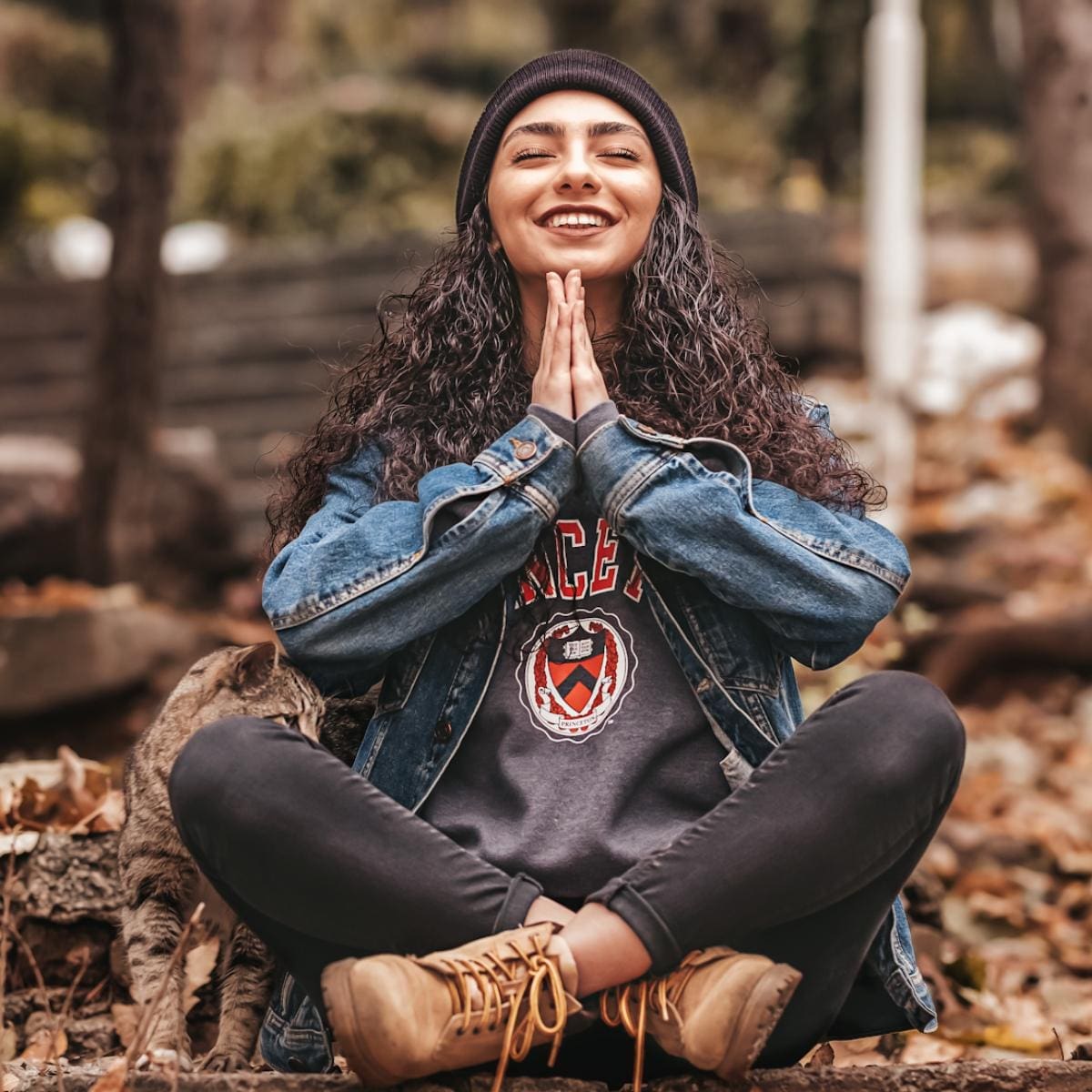 A happy woman meditating outside.