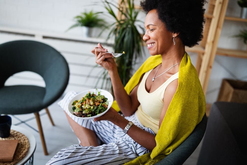 African american woman enjoying healthy foods that boost serotonin