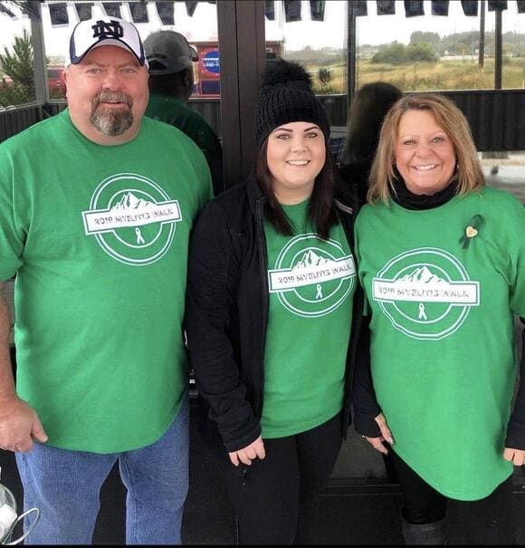 Manda is smiling with her family, while participating in a fundraiser. 

Photo credit: Manda Miller