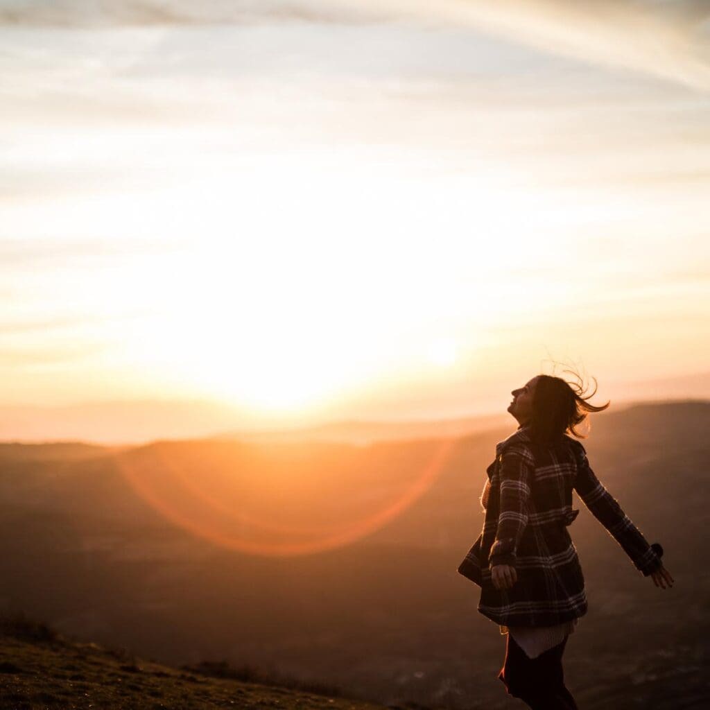 Woman walking in sunshine enjoying herself having fun 