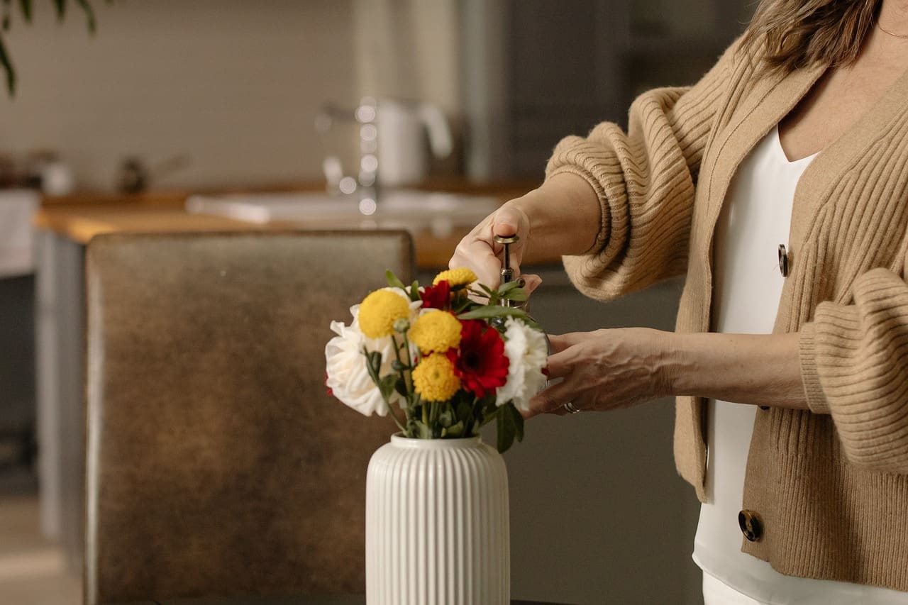 woman arranging flowers in a vase