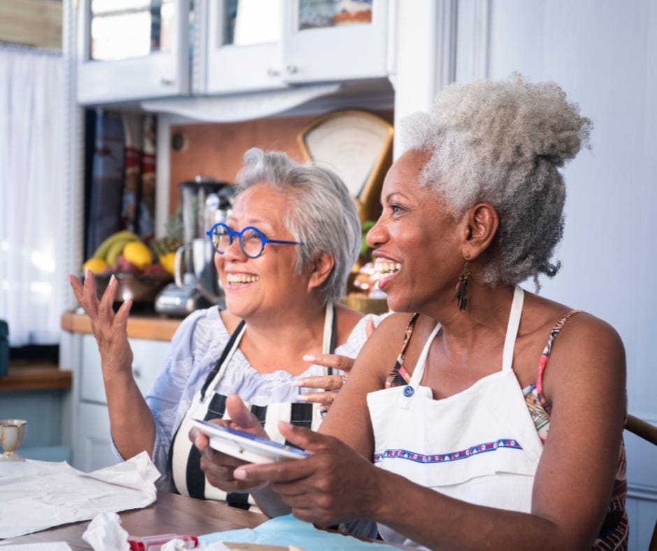 Two women of color having a good time doing kintsugi pottery