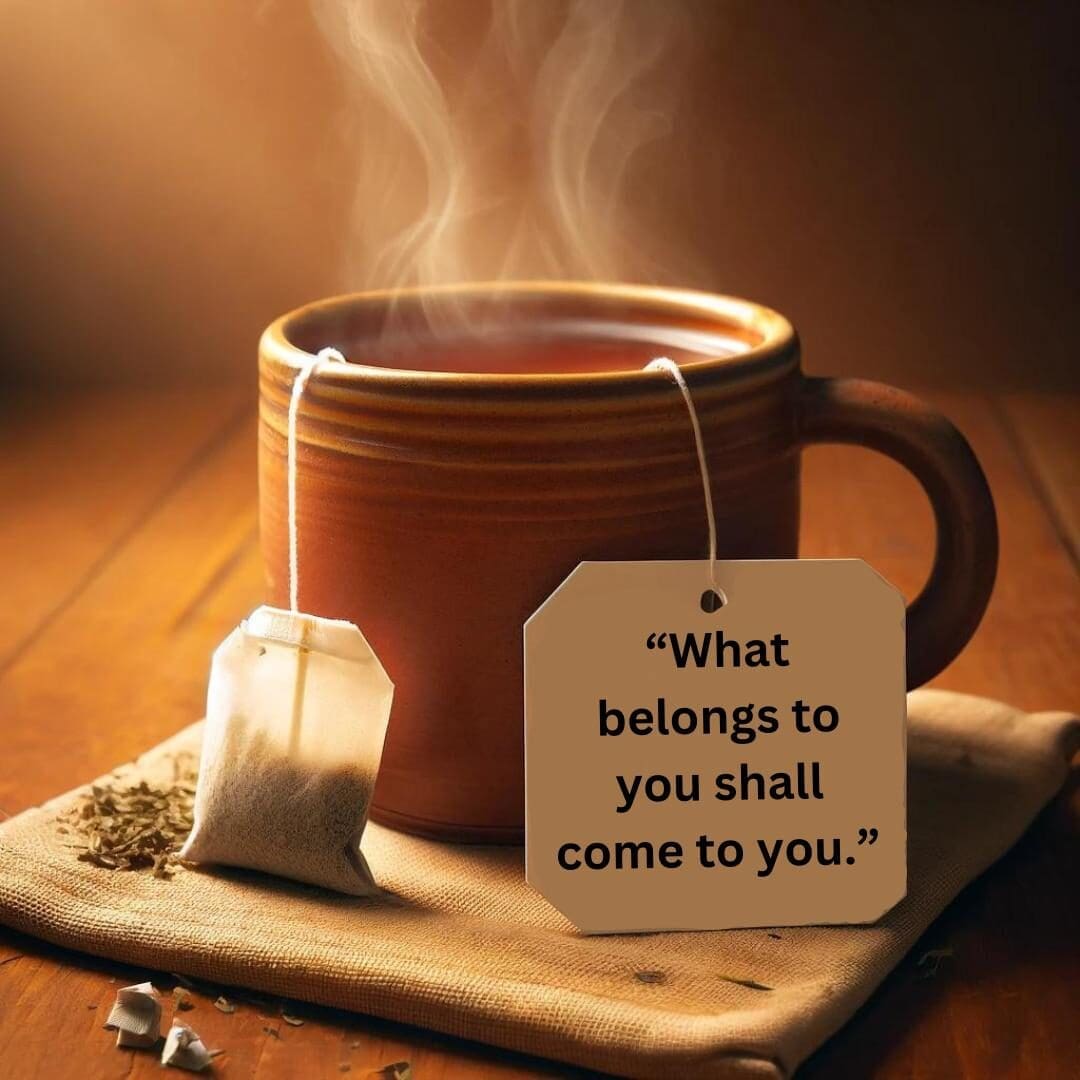 AI image of ceramic orange mug with steaming tea inside, an herbal tea bag sitting next to the mug and a string coming out of the cup with a tag that contains the Yogi tea bag quote: "What belongs to you shall come to you."