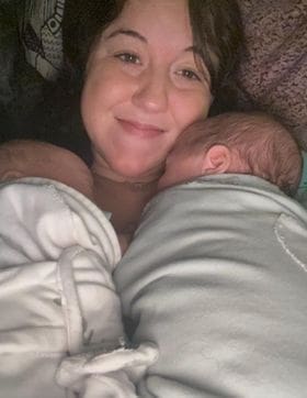 Kristin Oesterle holding her newborn twin sons. 