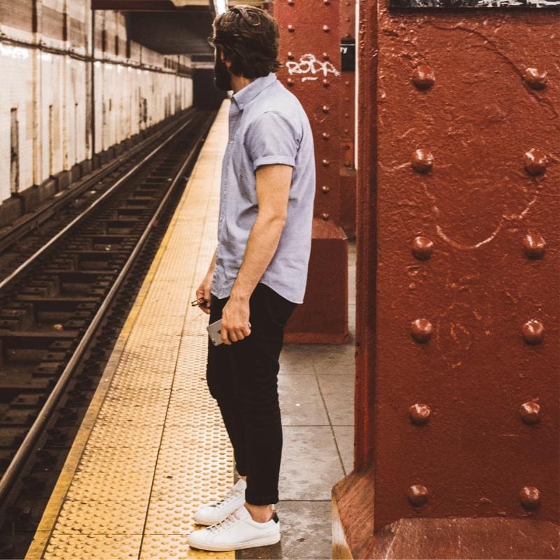 Man waiting patiently for subway train 