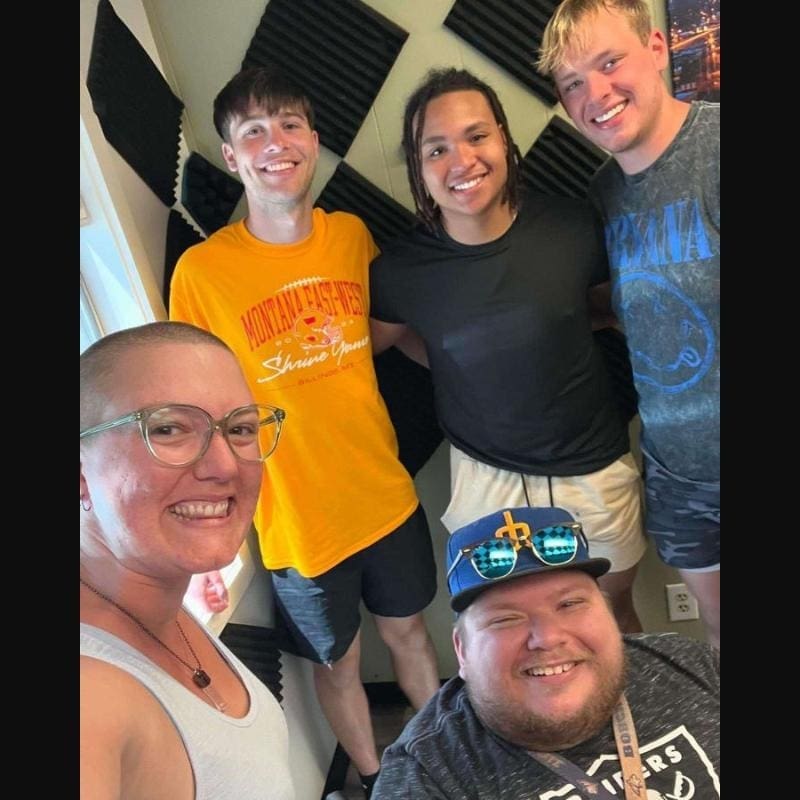 A photo of Mitch Bohn and his friends at the local radio station 98.5.