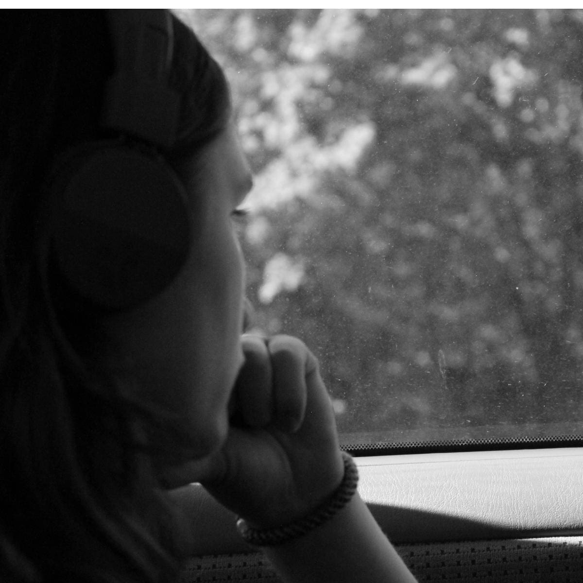 A woman crying, while looking out her car window. Symbolizing the words echoed in these sad quotes.