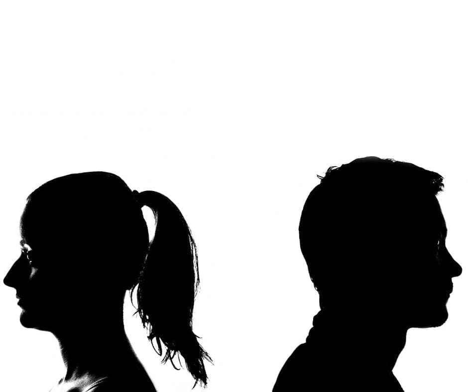 Shadow profiles of man and woman, facing away from each other on a white background.