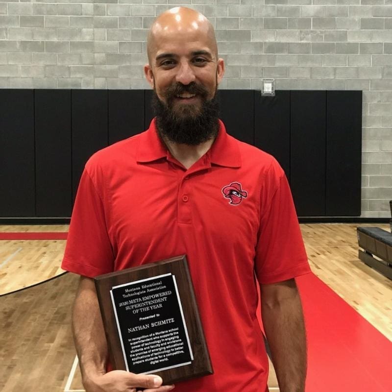 Nathan holding his award for META Empowered Superintendent, shortly before his constructive dismissal.